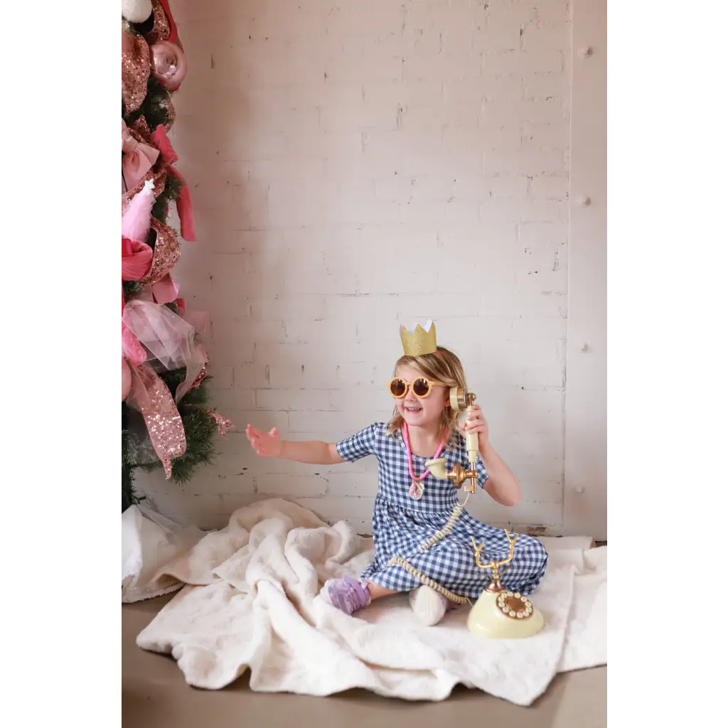 Vintage rotary phone with gold accents on gingham bamboo twirl dress