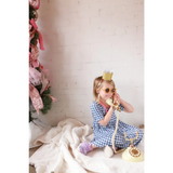 Vintage gold rotary phone on gingham bamboo twirl dress