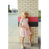 Cute pink gingham dress with gathered waist, perfect for stylish kids. Polished prints!