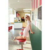 Retro diner stool with red vinyl and chrome base beside Gingham All Day Bamboo Twirl Dress