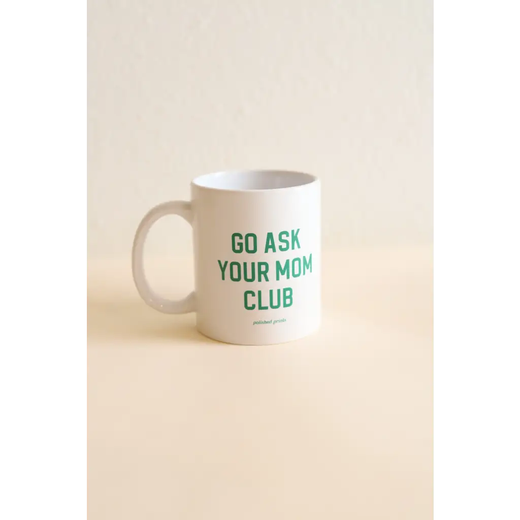 White ceramic mug with green text for the Go Ask Your Mom Club, a screen printed 11oz recommend