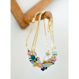 Colorful gold pull tie beaded bracelet with pastel hues and metal accents