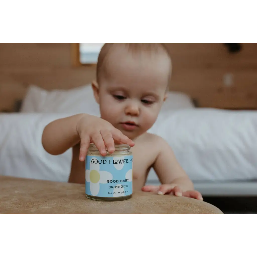 Good Baby Chapped Cheeks balm jar with good flower label for moms clothes