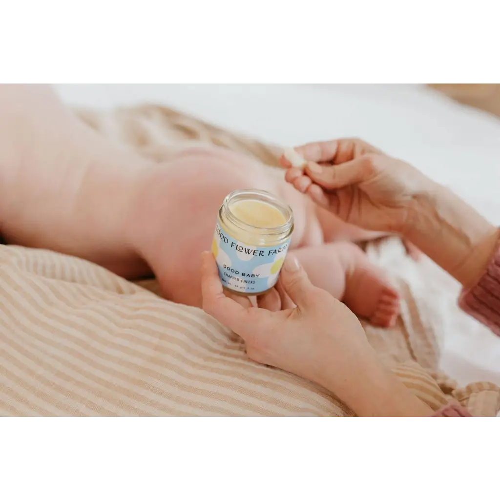 Good Baby Chapped Cheeks balm jar for moms in stylish clothes
