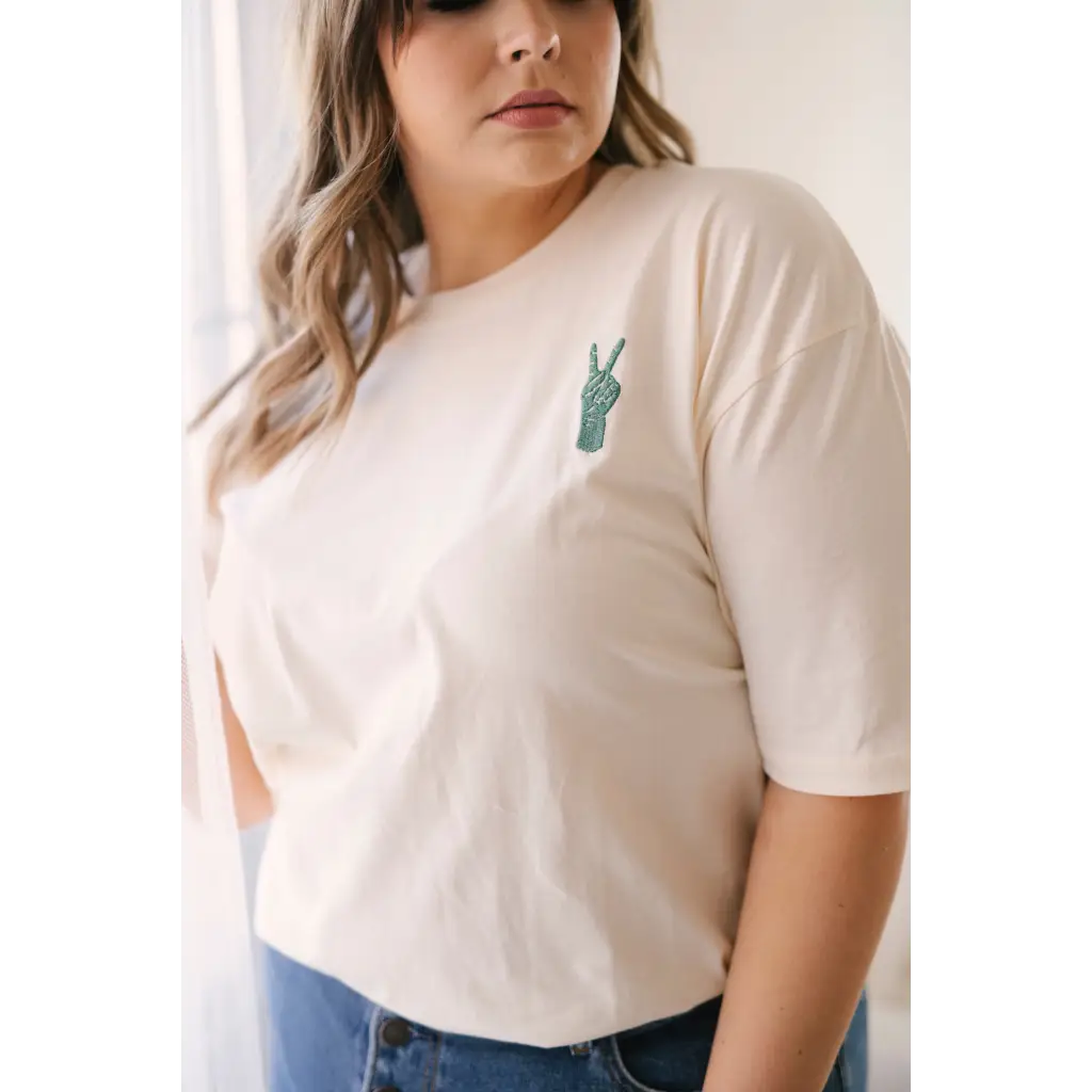 White Vibes Peace Embroidered Tee with small peace sign for good vibes peace lovers