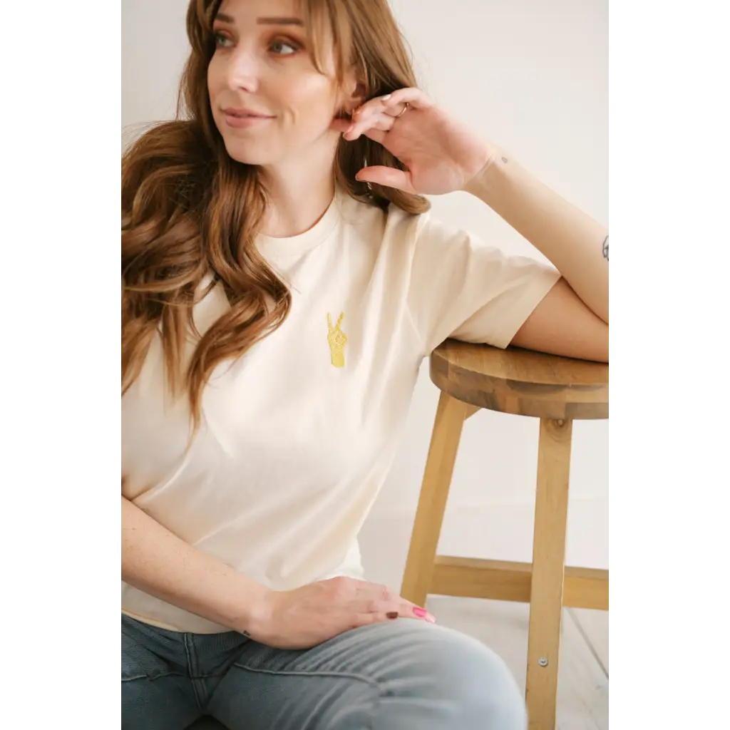 White Vibes Peace Embroidered Tee with a small yellow design for good vibes and style