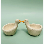 Two speckled off-white ceramic goose ring dishes with orange beaks