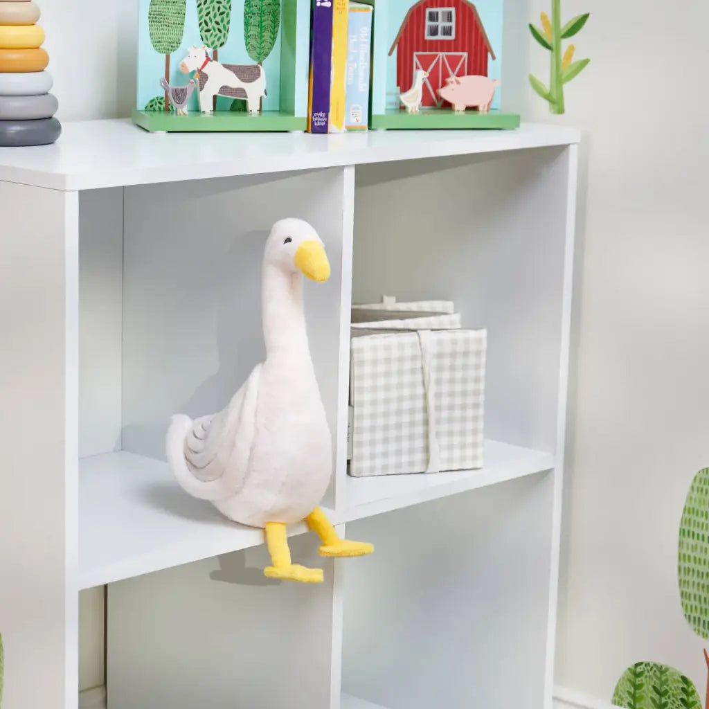 Cute goose softie plush with yellow beak on shelf
