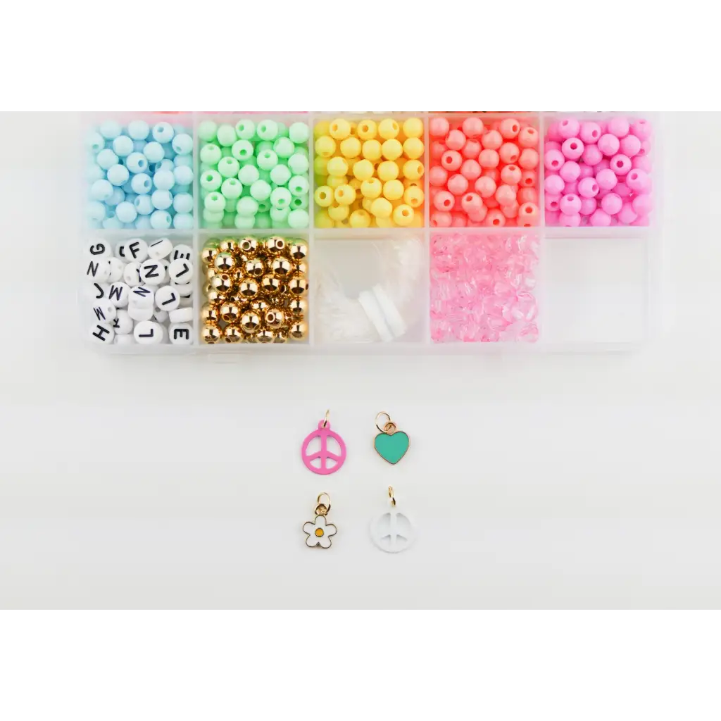 Colorful pastel plastic beads and charms in the Groovy Goals DIY Bracelet Craft Kit