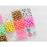 Plastic organizer packed with colorful beads for Groovy Goals DIY bracelet craft kit