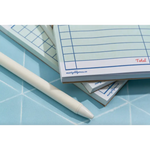 Stack of notepads with a pen for Grocery List, perfect for stylish moms or polished prints