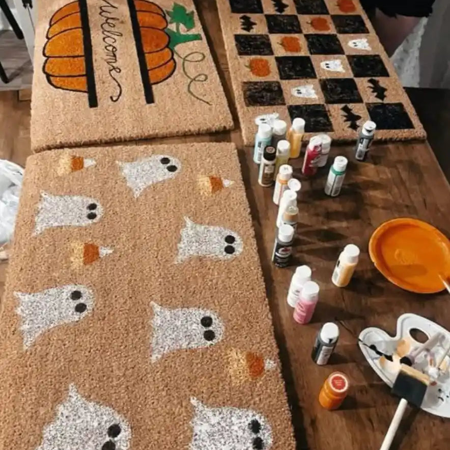 Hand-painted Halloween-themed doormats.