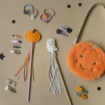 Halloween-themed hair accessories and fuzzy pumpkin purse for stylish womens clothes