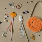 Halloween-themed hair accessories and fuzzy pumpkin purse for stylish womens clothes