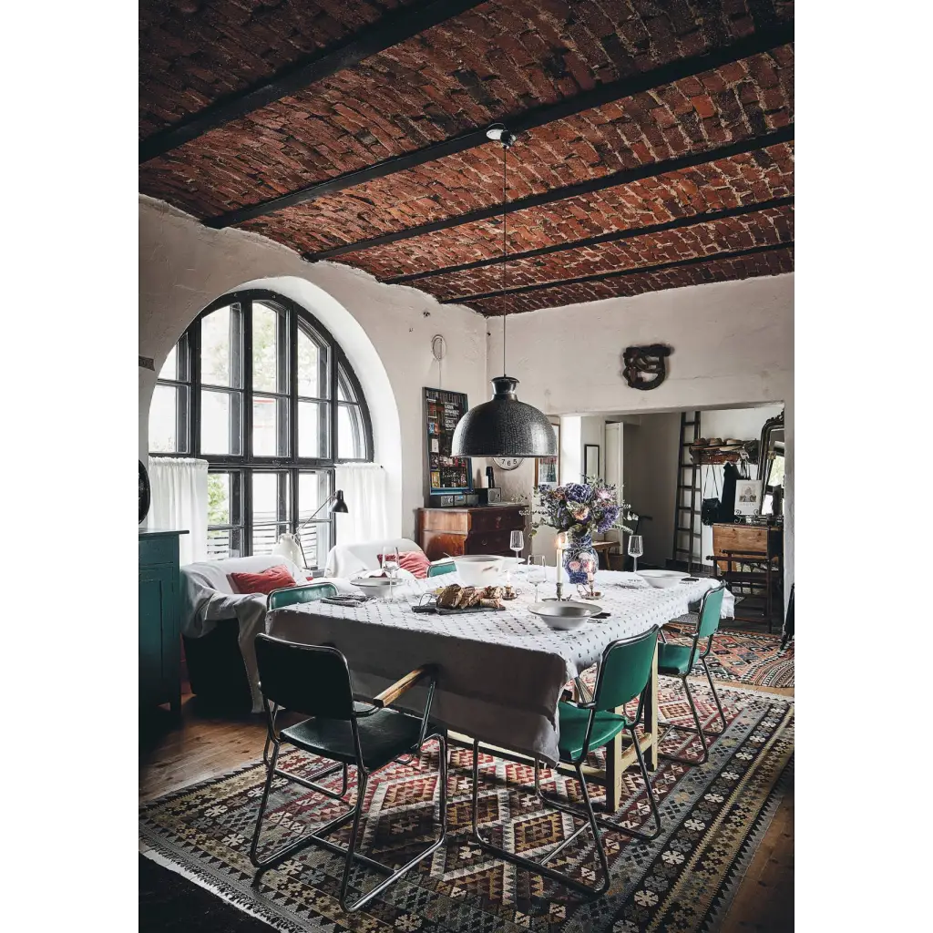 Happy Homes dining table with white patterned cloth and green chairs
