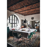 Happy Homes dining table with white patterned cloth and green chairs
