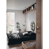 Happy Homes gold-framed mirror with polished prints reflecting room