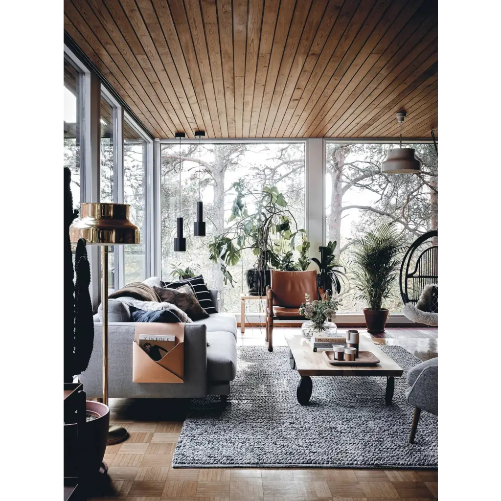 Gray Happy Homes sofa with pillows and tan leather holder