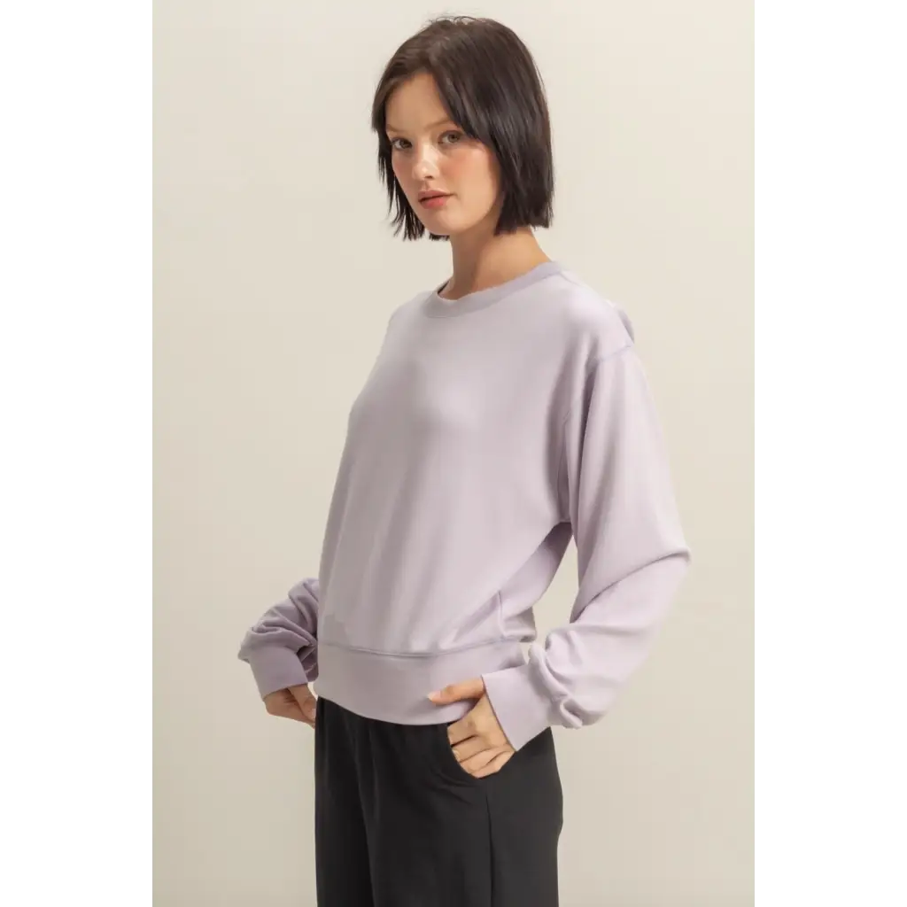 Woman wearing a Hazel Relaxed Long Sleeve Sweatshirt in lavender color