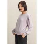 Woman wearing a Hazel Relaxed Long Sleeve Sweatshirt in lavender color