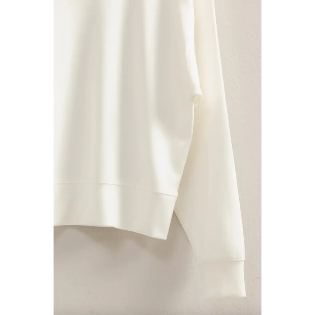 White fabric draping beautifully on the Hazel Relaxed Long Sleeve Sweatshirt, stylish womens clothes