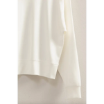 White fabric draping beautifully on the Hazel Relaxed Long Sleeve Sweatshirt, stylish womens clothes