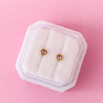 Gold heart gemstone stud earrings with pink stones in fur box