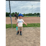 Toddler in baseball cap on field rocking Here for the Holidays Brutally Honest Tee in Organic Cotton