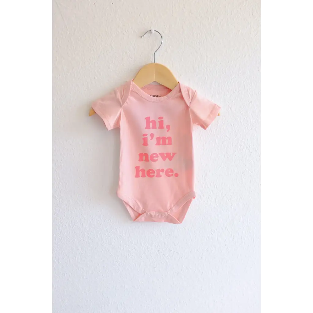 Pink organic cotton baby onesie with hi, I’m new here text for adorable new arrivals