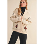 Cream-colored Holly Horse Knit Sweater Cardigan with black geometric patterns and red horse motifs