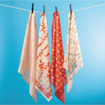 Four patterned scarves on a clothesline featuring polished prints, perfect stylish womens clothes for moms