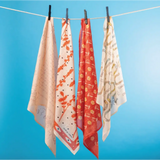 Four patterned scarves on a clothesline featuring polished prints, perfect stylish womens clothes for moms