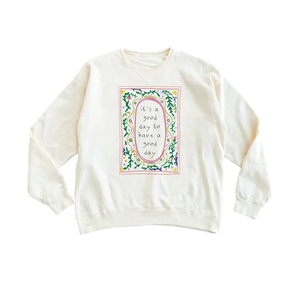 Cream-colored long-sleeved sweatshirt with good day script in polished prints