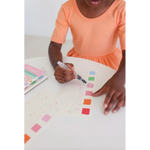 Child’s hand coloring in Ice Cream Pocket Watercolor Book with polished prints style