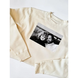 Cream-colored Sally pullover featuring a classic Harry Met Sally photo on top