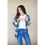 Person in plaid flannel and blue jeans, showcasing It Takes a Village Adult Retro Ringer Tee