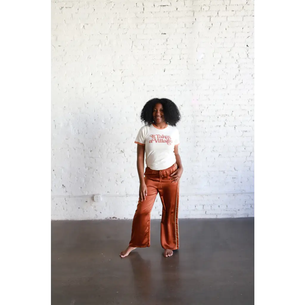 Person wearing a white Adult Retro Ringer Tee with rust-colored wide-leg pants