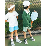 Two young players showing off their Play Nice Mini Pickle Ball Paddles on court