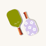 Two mini pickle ball paddles for kids, one green and one purple floral design