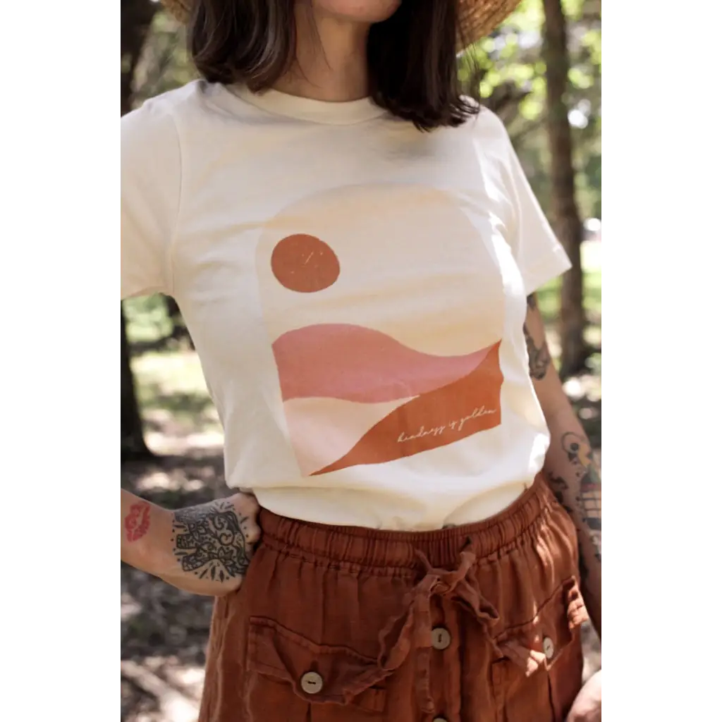 Golden Relaxed Graphic Tee featuring minimalist pink desert landscape and sun design