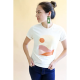 White Golden Relaxed Graphic Tee with minimalist sunset design and green earrings