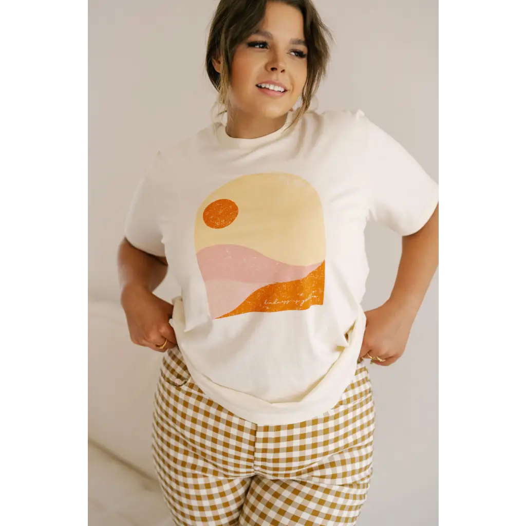 Golden Relaxed Graphic Tee with minimalist sunset design in orange and pink tones