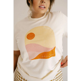 Golden Relaxed Graphic Tee with minimalist desert sunset in peach, orange, and yellow tones