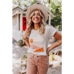 Joyful person in a wide-brimmed hat rocking the Golden Relaxed Graphic Tee and pink pants