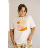 White graphic tee with a minimalist sunset design in orange and pink tones