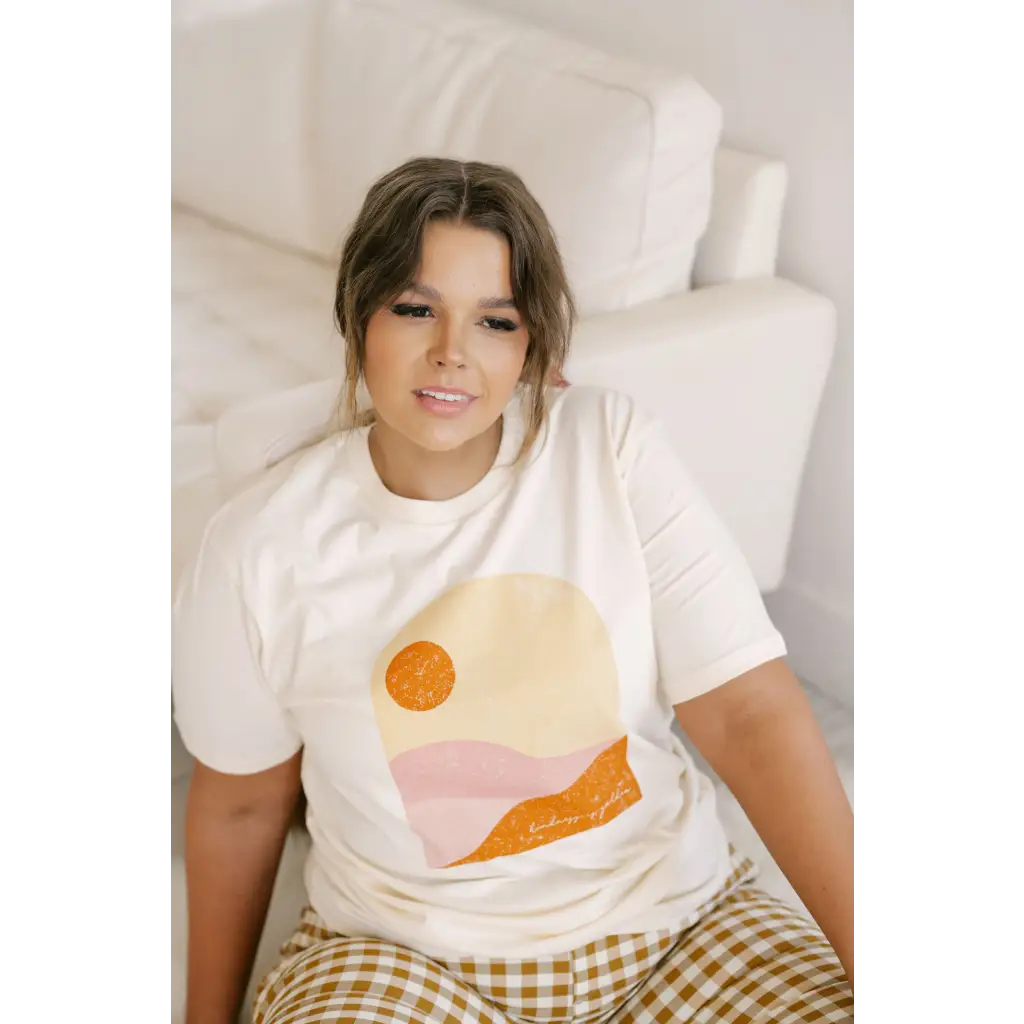 Golden Relaxed Graphic Tee with a cool abstract sunset design in orange and pink