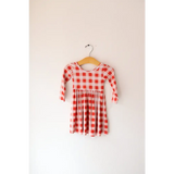 Red and white gingham Kit Plaid Dress for Girls hanging on a hanger ready to twirl