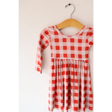 Red and white gingham Kit Plaid Dress for Girls on a wooden hanger, perfect for twirling