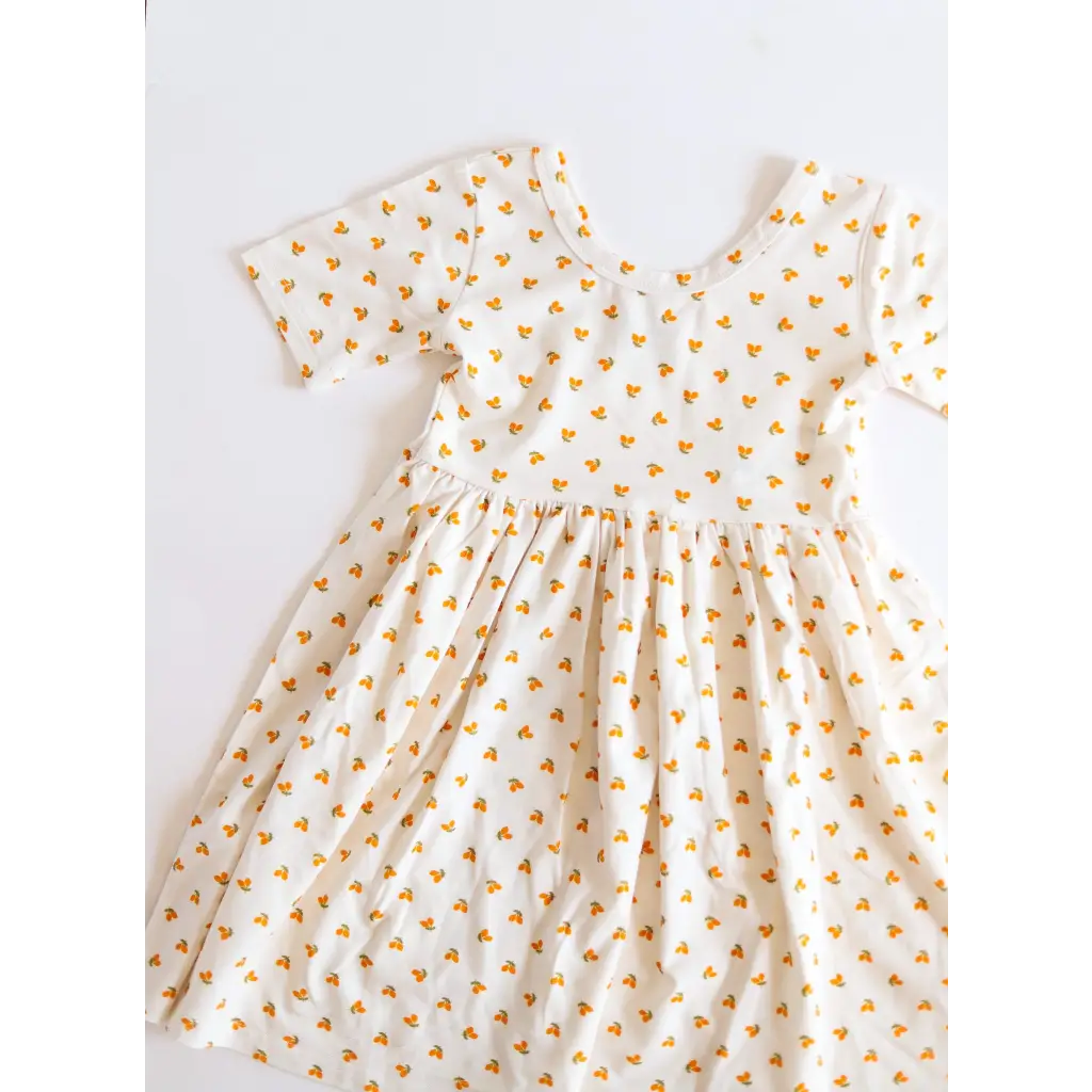 Cute Lemon Shake Up Twirl Dress with orange heart pattern and short sleeves for kids