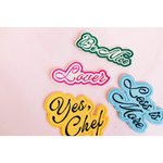 Colorful iron-on patches featuring fun phrases for stylish womens clothes inspiration